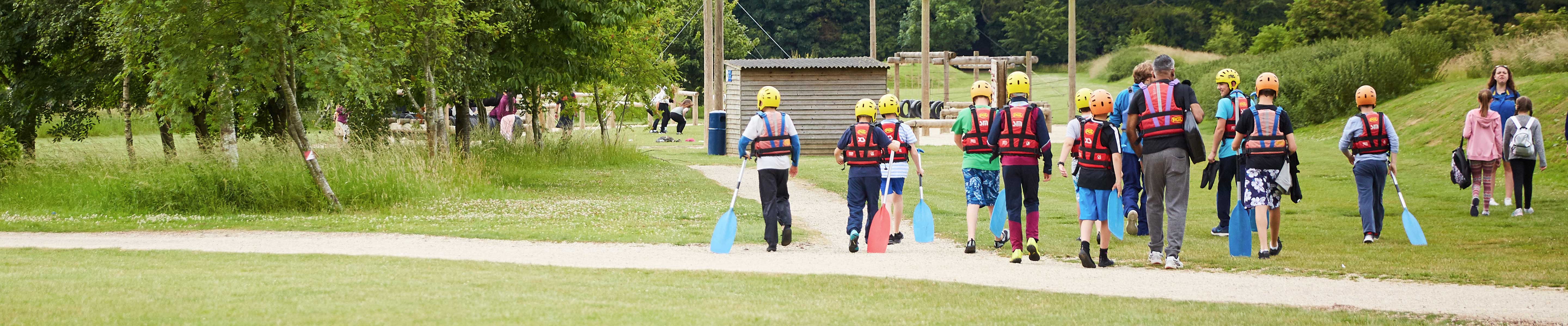 A group of children walking across an activity centre